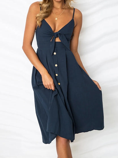 Cutout Smocked Sweetheart Neck Cami Dress with Decorative Button and Opaque Design in deep navy, beautifully styled and flowing gracefully.