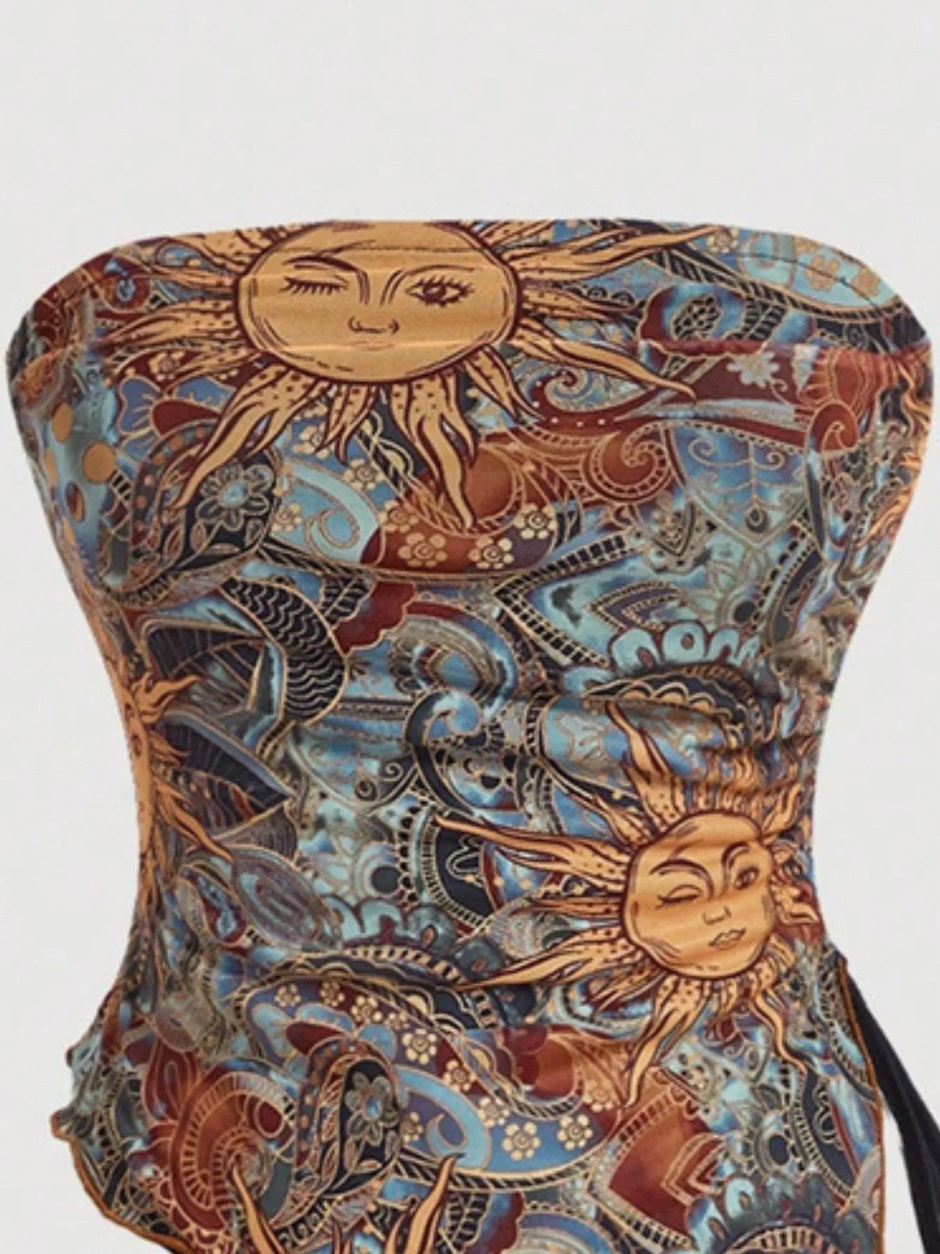 Detailed view of the Trendsi Asymmetrical Drawstring Printed Tube Top highlighting the unique sun design, ideal for contemporary women's fashion. Ruched for a stylish appearance.