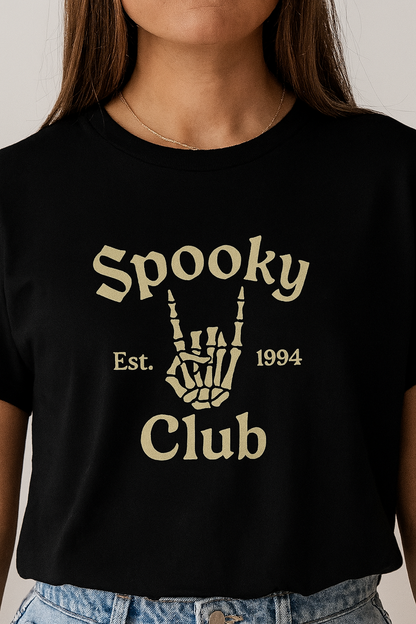 Unisex Spooky Club Tee showcasing a skeleton hand gesture with text design, perfect for Halloween enthusiasts, made from soft 100% cotton.