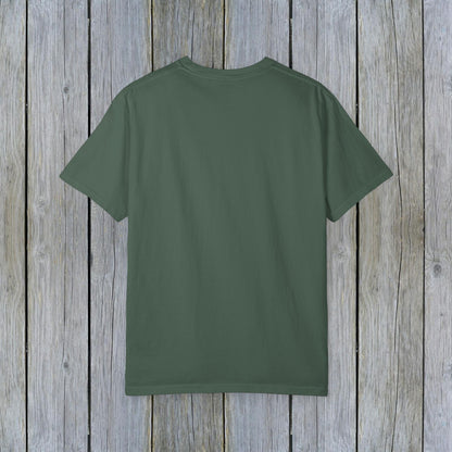 Back view of Unisex Garment-Dyed Lake Rules Tee in earthy green, perfect for outdoor adventures, presented against a textured wooden background.