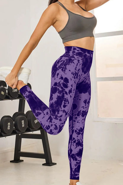 Model demonstrating the flexibility of Slightly Stretchy Tie-Dye High Waist Active Leggings in purple during a workout.