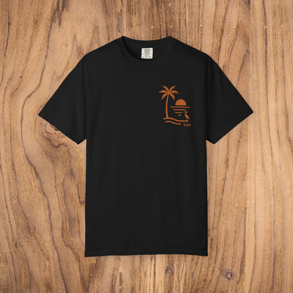 Unisex Sunset Palm Tree T-Shirt in black, highlighted by a trendy palm tree sunset graphic, made from high-quality garment-dyed cotton in a relaxed fit.