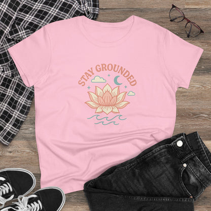 Stay Grounded Spiritual Tee - Comfortable Crop Top displayed on wood background, in pink with a lotus flower graphic, ideal for warm weather and vacations.