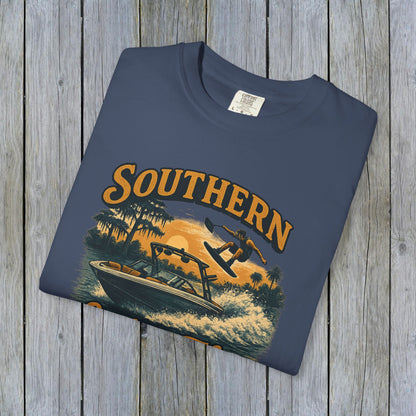 Southern Lake Flow T-Shirt displayed flat on a wooden surface, showcasing eco-friendly design and vibrant colors, crafted from 100% US cotton for durability and style.