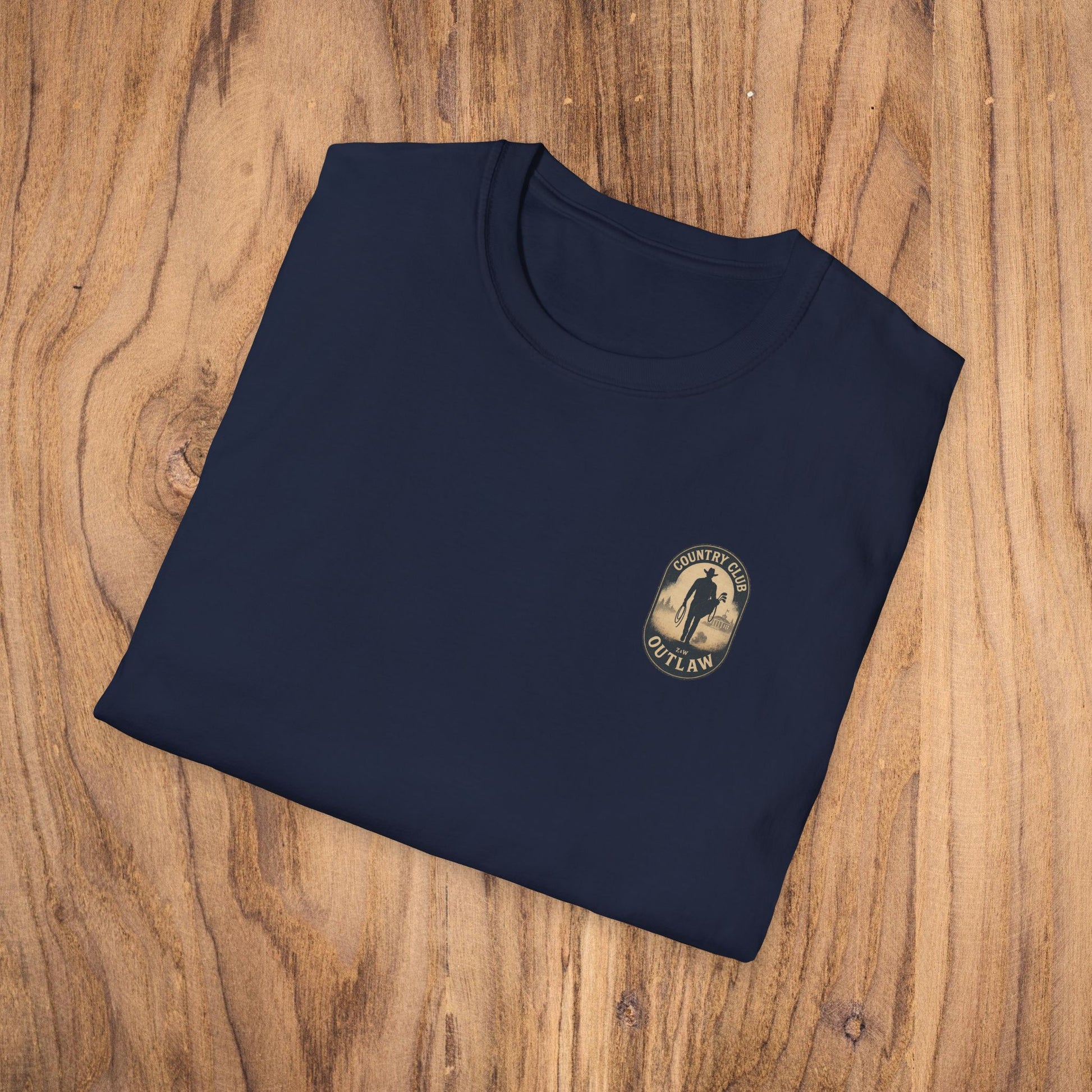 Vintage Southern Gentleman Golf Shirt showcased on a wooden surface, featuring the 'Country Club Outlaw' emblem for a rustic, stylish appeal.