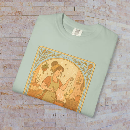 Culinary Queen Tarot Tee in pastel green, featuring a delightful design of a woman preparing food, available in sizes S to 4XL, crafted from soft cotton material.
