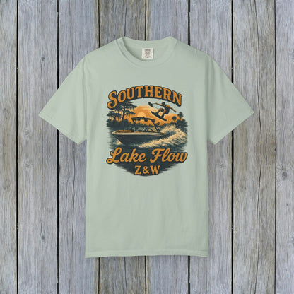 Southern Lake Flow T-Shirt in soft mint green, displaying a lively design of a person skiing on water, made from eco-friendly 100% US cotton, sizes range from S to 4XL.
