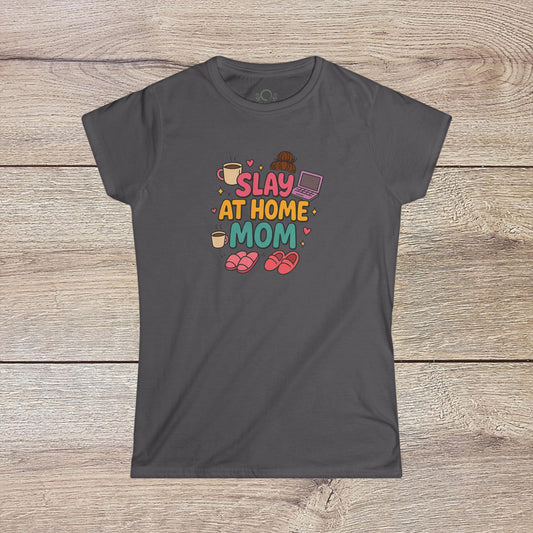 Slay At Home Mom T-Shirt showcasing a vibrant and humorous graphic design, featuring playful illustrations of coffee cups, a laptop, and cozy slippers, perfect for moms who embrace their stay-at-home lifestyle. Comfortable cotton fabric available in sizes S to 4XL.