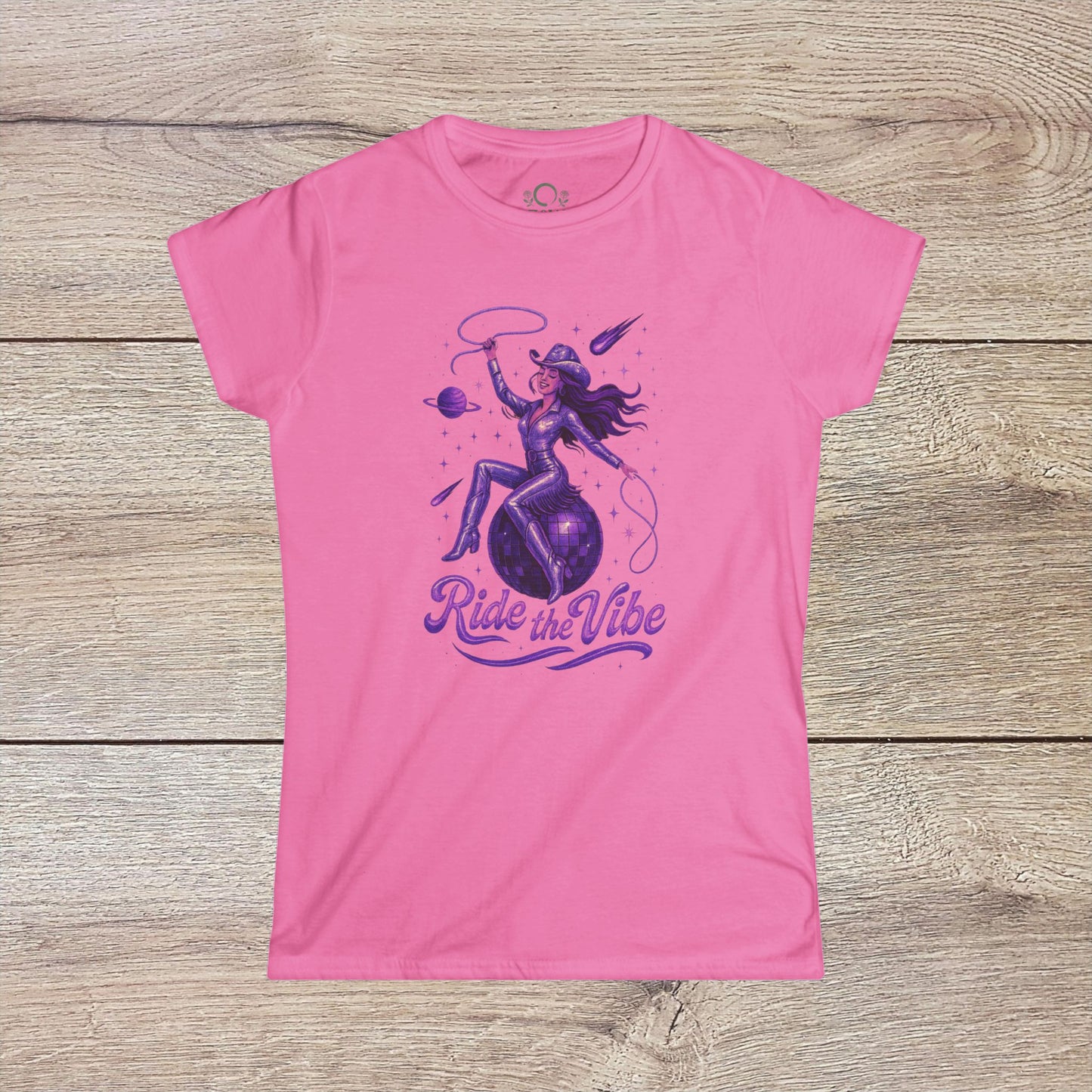 Vibrant Ride The Vibe Tee in pink featuring a stylish graphic design of a woman riding a planet, perfect for showcasing unique style and comfort.