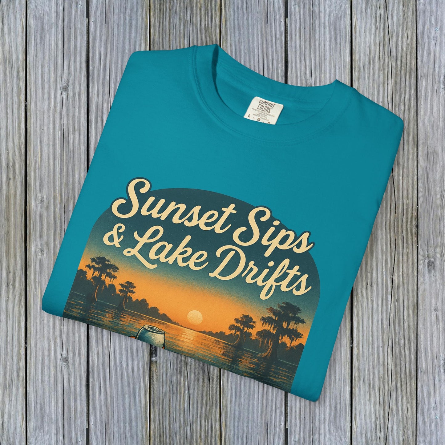 Lake Drifts T-Shirt in teal with 'Sunset Sips & Lake Drifts' design, a stylish choice for lakeside adventures.