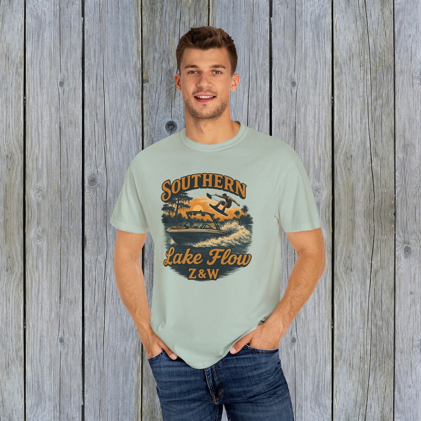 Southern Lake Flow T-Shirt worn by a man, in a soft pastel green shade, emphasizing its eco-friendly 100% US cotton fabric and stylish graphic.