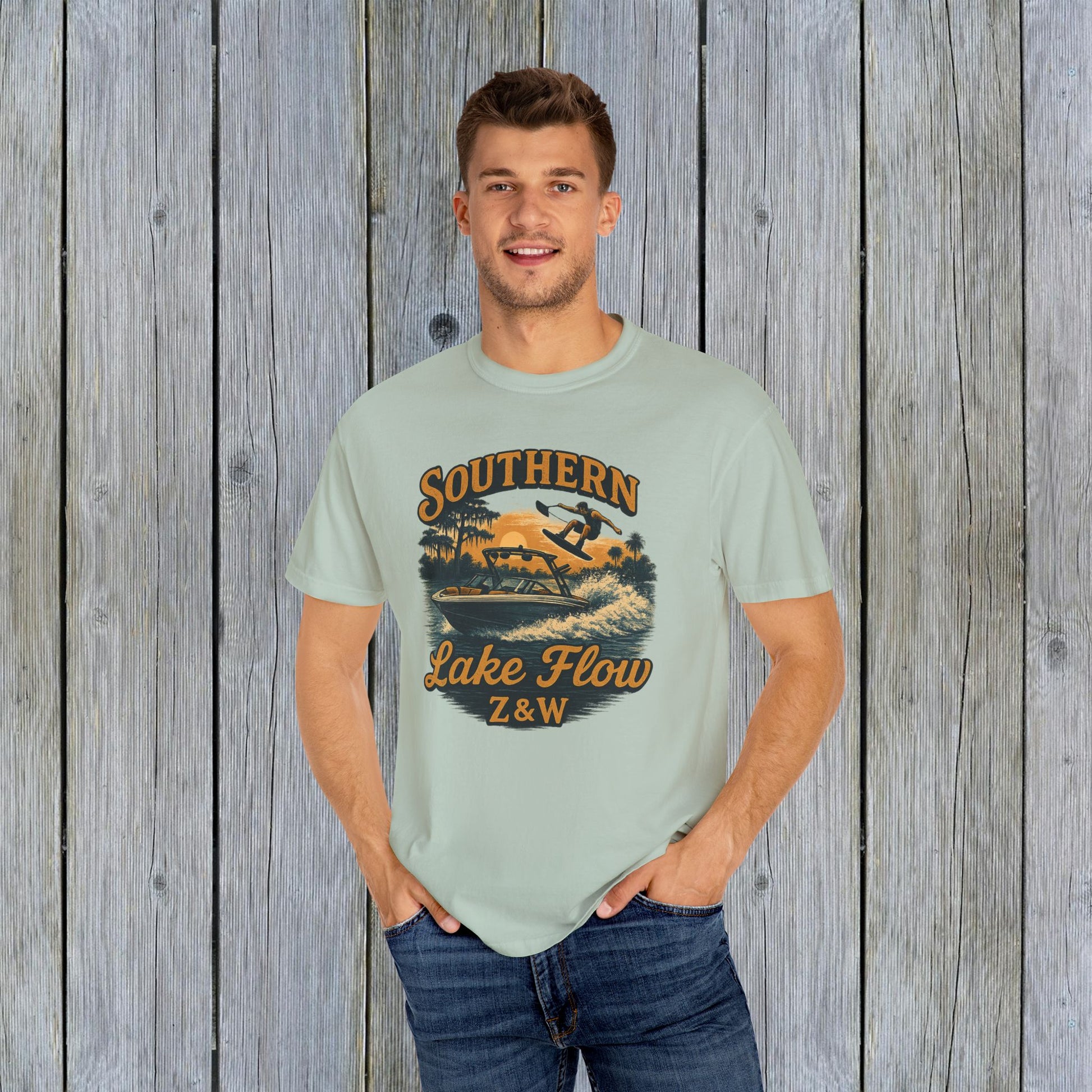 Southern Lake Flow T-Shirt worn by a man, in a soft pastel green shade, emphasizing its eco-friendly 100% US cotton fabric and stylish graphic.
