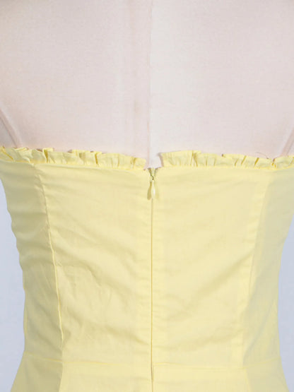 Detailed view of the zip back of the trendy slit sleeveless midi dress, emphasizing the craftsmanship and modern design in a cheerful yellow shade.