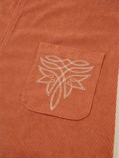 Close-up of the embroidered patch pocket on the Corduroy Western Mini Dress With Embroidered Patch Pocket, highlighting the intricate design and perfect blend of fashion and function.