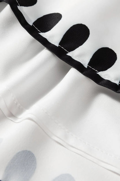 Close-up of Tied Printed Shorts showcasing stylish black and white polka dot fabric detail, perfect for summer fashion.