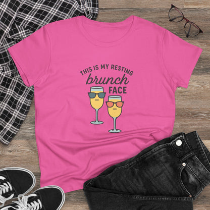 Stylish women's premium brunch face tee in pink, displayed with black shorts and plaid shirt, highlighting its comfortable cotton fabric.