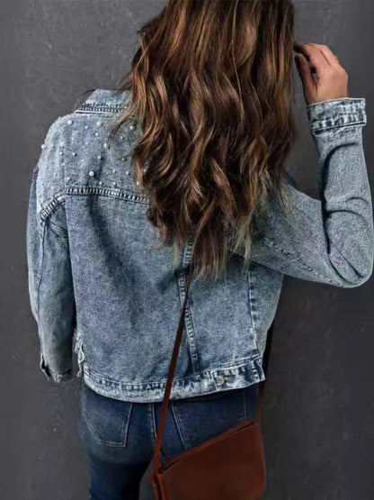 Back view of a Plus Size Denim Jacket with Pearl Detail and Button Up Closure, highlighting the intricate pearl design and relaxed style.