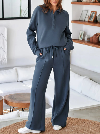 Model showcasing the Trendsi Collared Sweatshirt & High Waist Pants Two-Piece Active Set - Soft Cotton Blend in a chic indoor setting, wearing a stylish blue sweatshirt and matching pants.