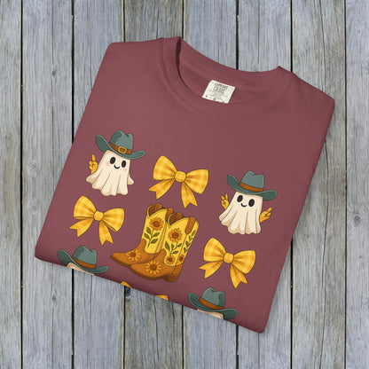Cute Halloween T-Shirt featuring ghosts, cowboy boots, and bows, perfect for unisex fall fashion. Made from eco-friendly fabric for a sustainable choice.
