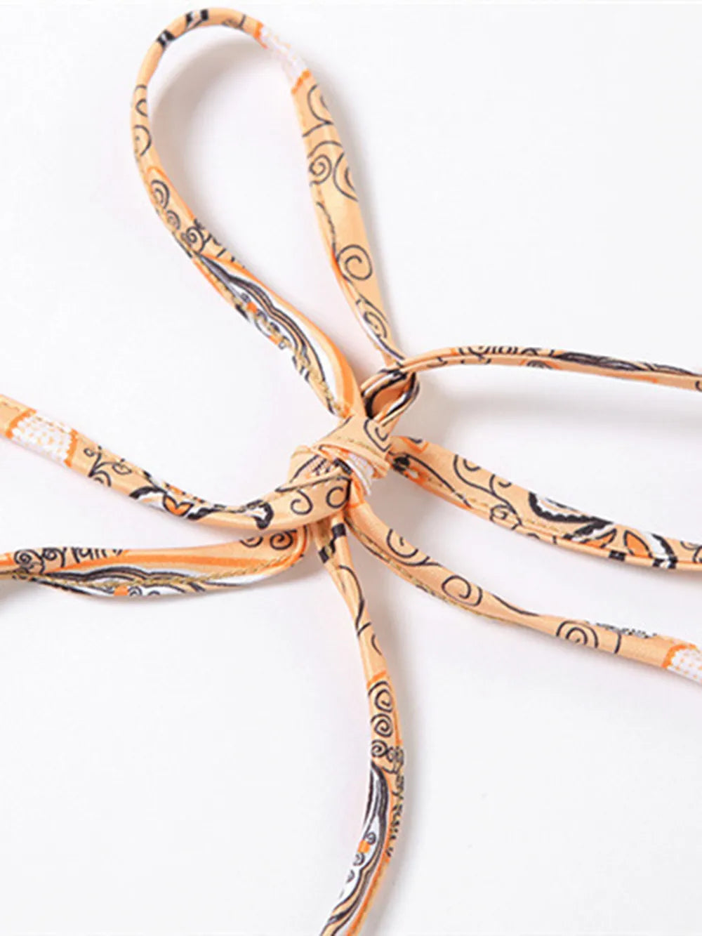 Close-up view of the tied straps of the Trendy Printed Halter Neck Cami Top, emphasizing the intricate detailing and design.