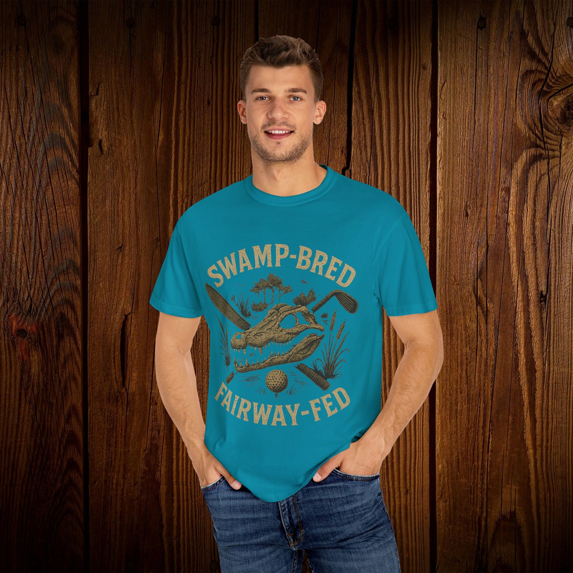 Model showcasing the Unisex Swamp-Bred Fairway-Fed Tee in vibrant turquoise, featuring a bold design suited for golf enthusiasts who appreciate style.