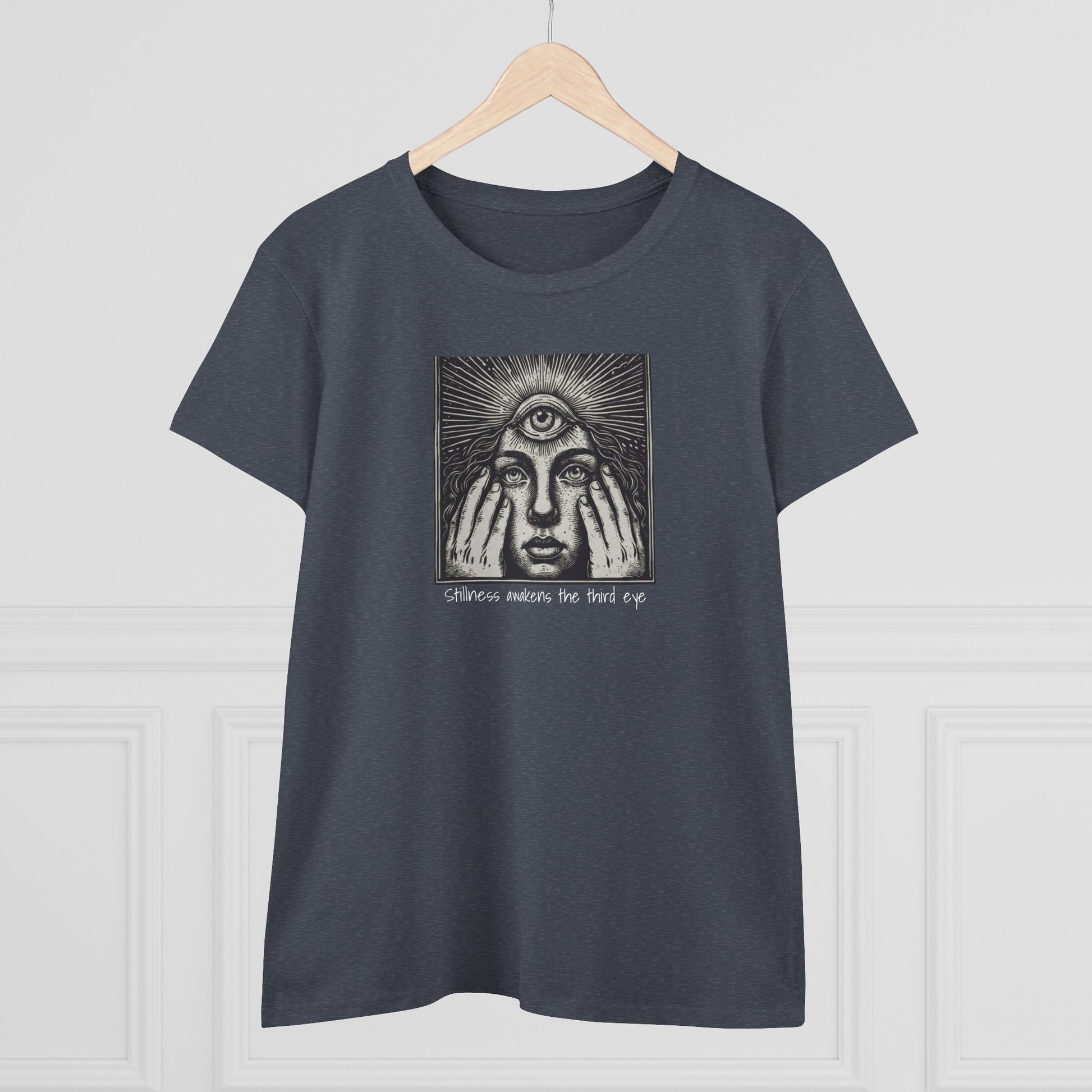 Stylish Third Eye Graphic Tee displayed on a wooden hanger, featuring a unique design with a third eye and text, symbolizing awareness and intuition. Made from 100% cotton for a comfortable fit.