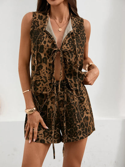 Chic woman wearing a trendy leopard print tie front tank & denim shorts two-piece set, showcasing a stylish and casual look.