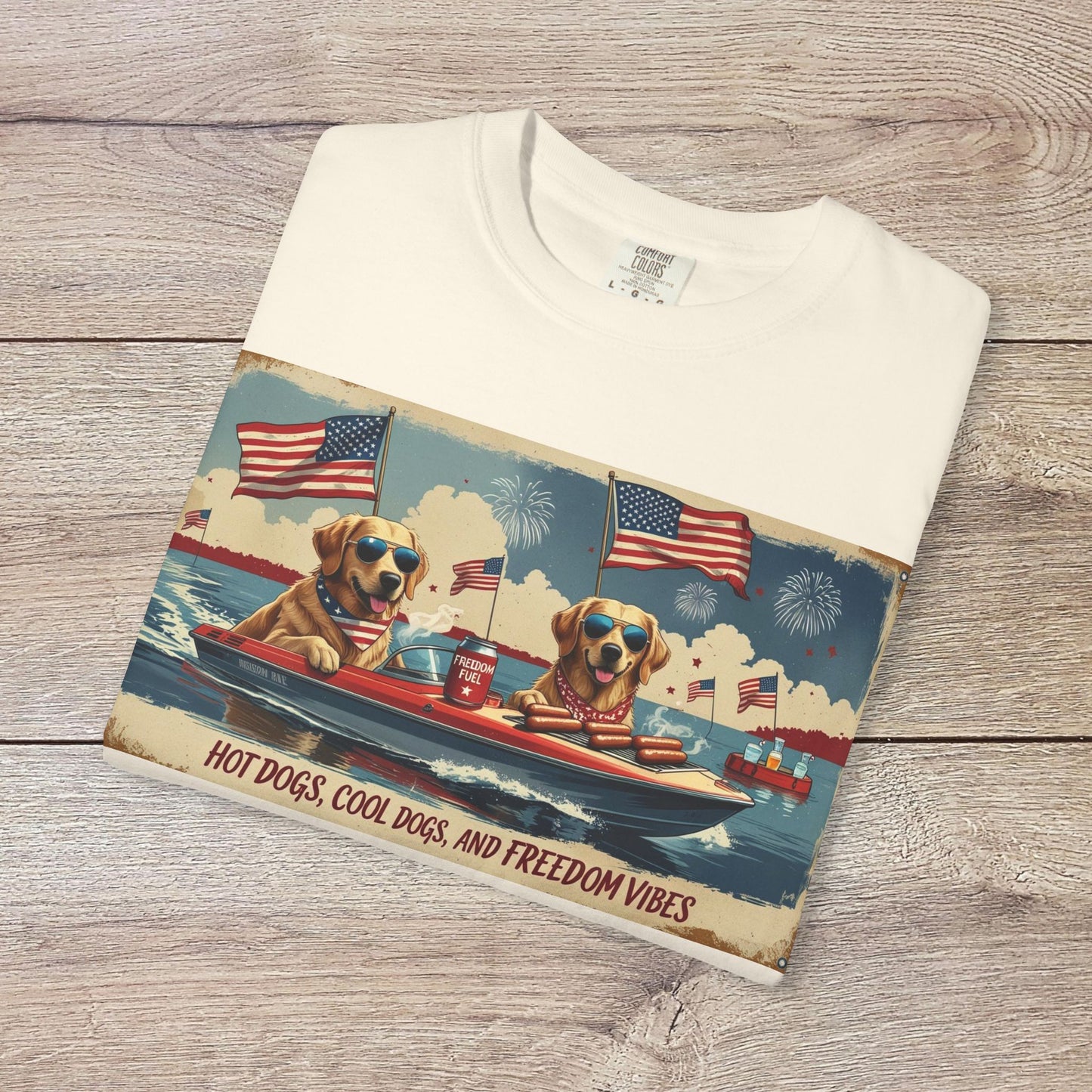 Men's Golden Tee featuring a playful design with dogs in sunglasses on a boat with patriotic elements, ideal for summer vibes. Comfortable cotton t-shirt with ribbed collar.