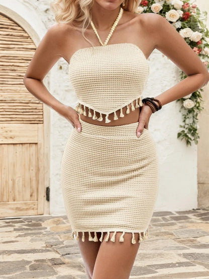 Close-up of the Trendy Waffle-Knit 2-Piece Halter Neck Top and Skirt Set, emphasizing tassel accents and a summer-ready aesthetic.
