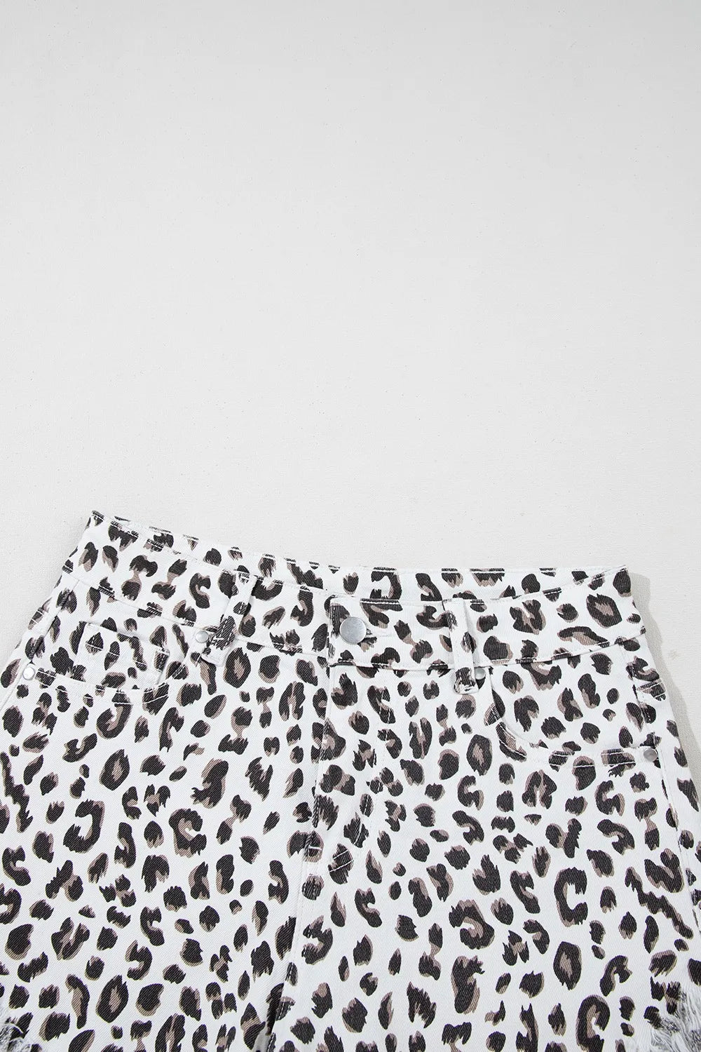 Leopard Frayed Hem Denim Shorts displayed from above, emphasizing the stylish leopard print and the raw hem detail, ideal for casual outfits.