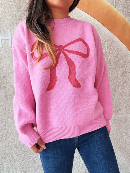 Stylish bow pattern casual long sleeve sweater in pink, perfect for effortless everyday wear. Model highlighting its cozy fit.