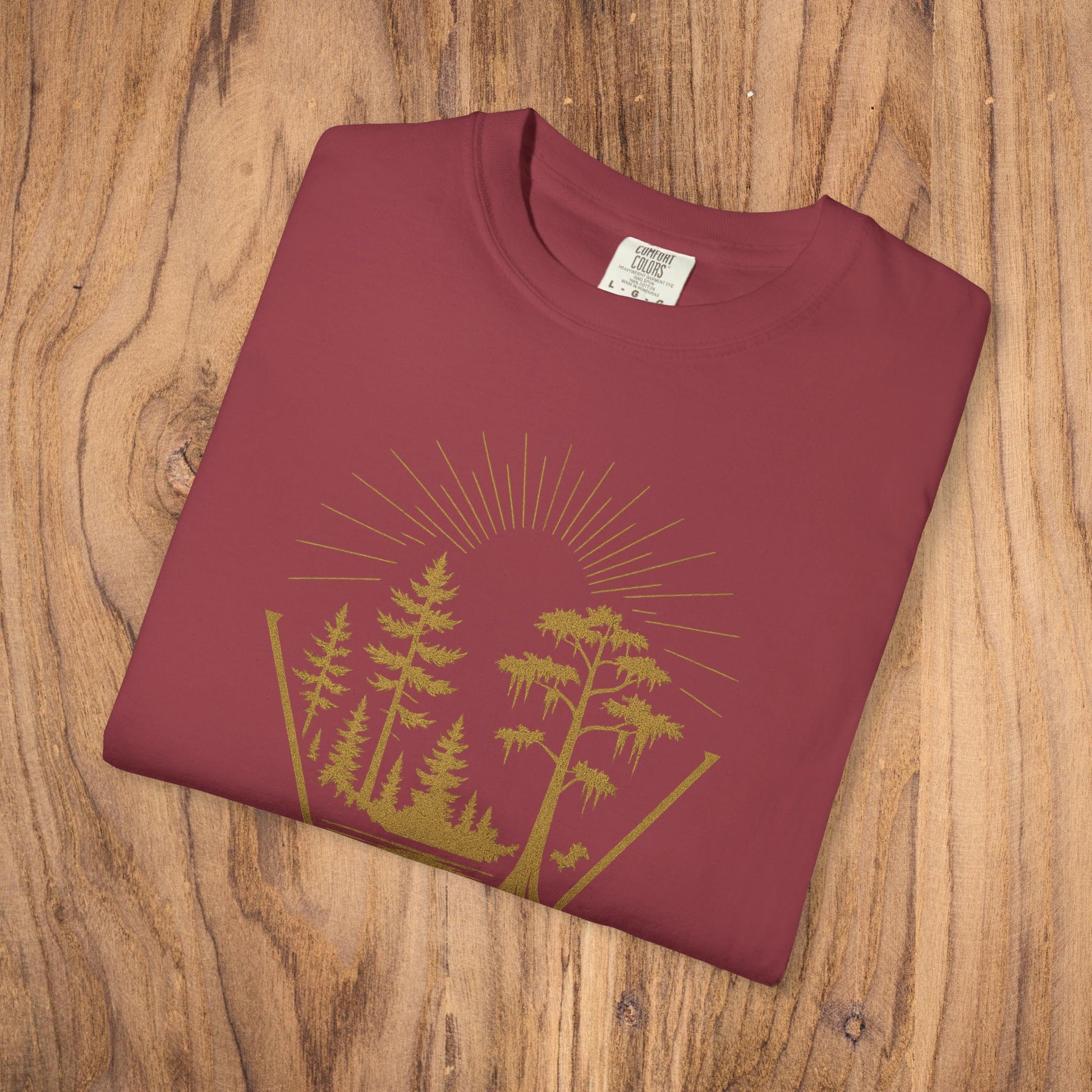 Nature Outdoor Vibes Tee - Soft 100% US Cotton, folded and displaying a beautiful forest landscape design, emphasizing comfort and durable construction.