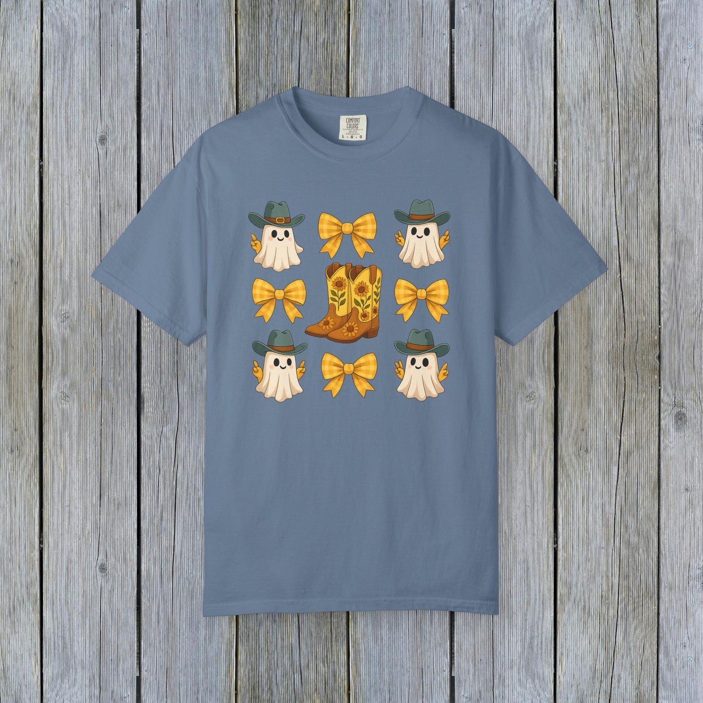 Cute Halloween T-Shirt displayed with cheerful ghosts, cowboy hats, and yellow bows, paired with a stylish cowboy boot, designed with eco-friendly fabric.