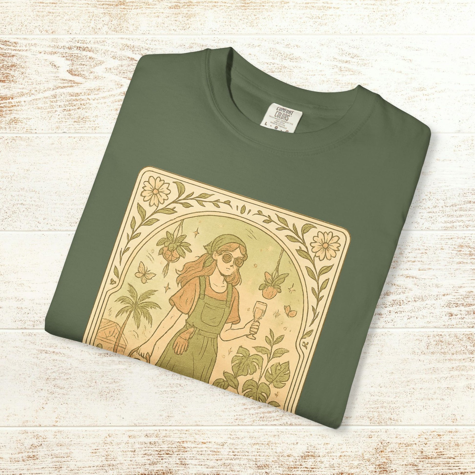Rooted One Tarot Tee in olive green, showcasing a playful design of a girl with sunglasses and nature elements, crafted from ethically sourced cotton, offered in sizes S-4XL.