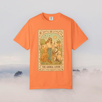 Animal Lover Tarot Tee in vibrant orange color displaying a charming illustration of a woman with several pets, ideal for expressing love for animals.