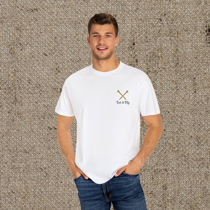 Model wearing a white Tee It High Let It Fly Graphic Tee, featuring 'Let It Fly' text and crossed golf clubs, exuding a stylish and laid-back vibe.