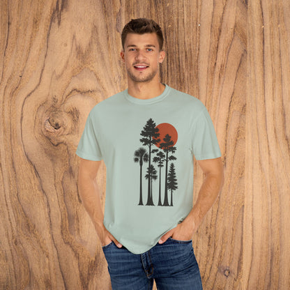 Sunset Trees Unisex T-Shirt displayed by a model, showcasing a soft 100% cotton garment-dyed design with a unique sunset and tree graphic.
