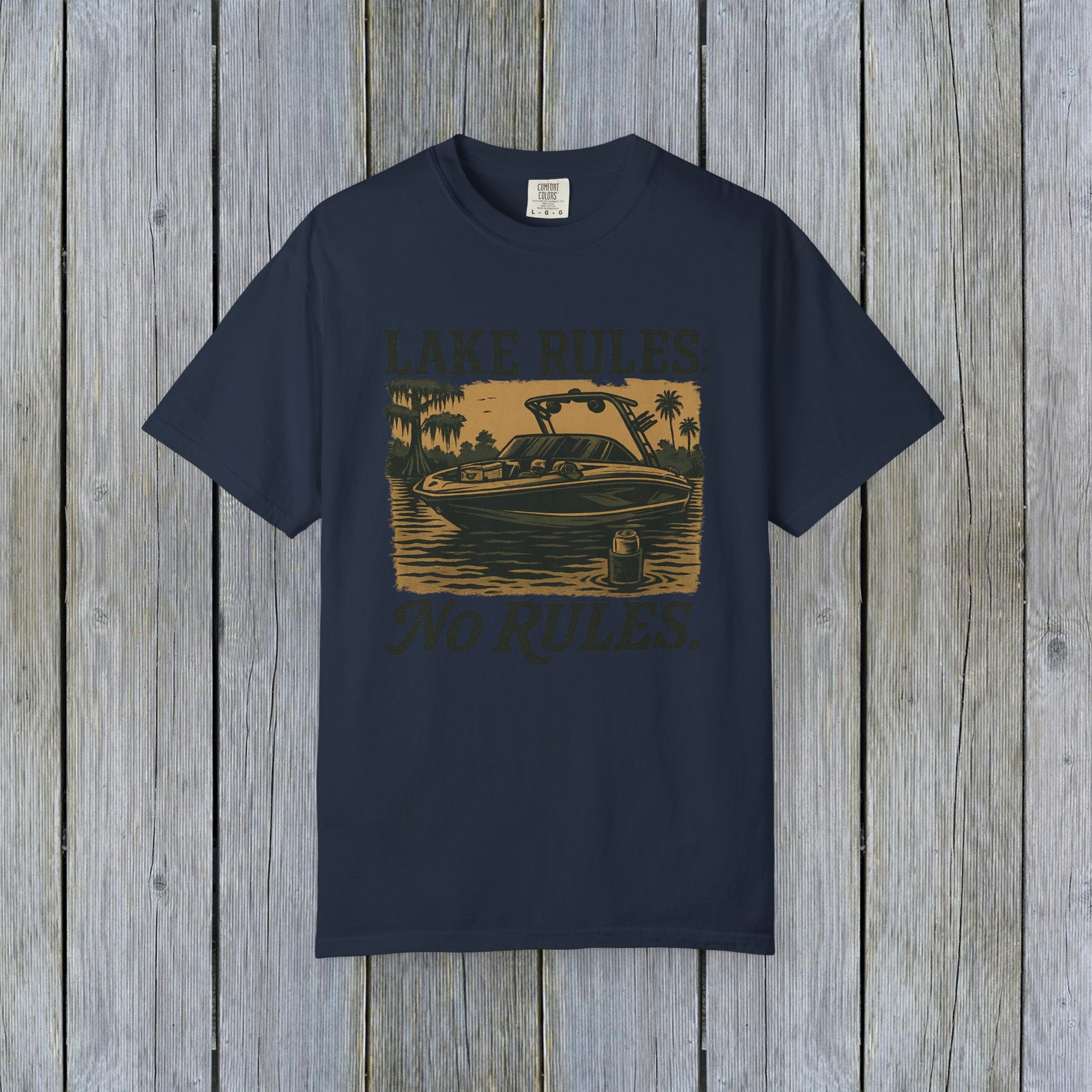 Front view of Unisex Garment-Dyed Lake Rules Tee showcasing a boat graphic and 'Lake Rules: No Rules.' Designed for comfort and outdoor adventures.
