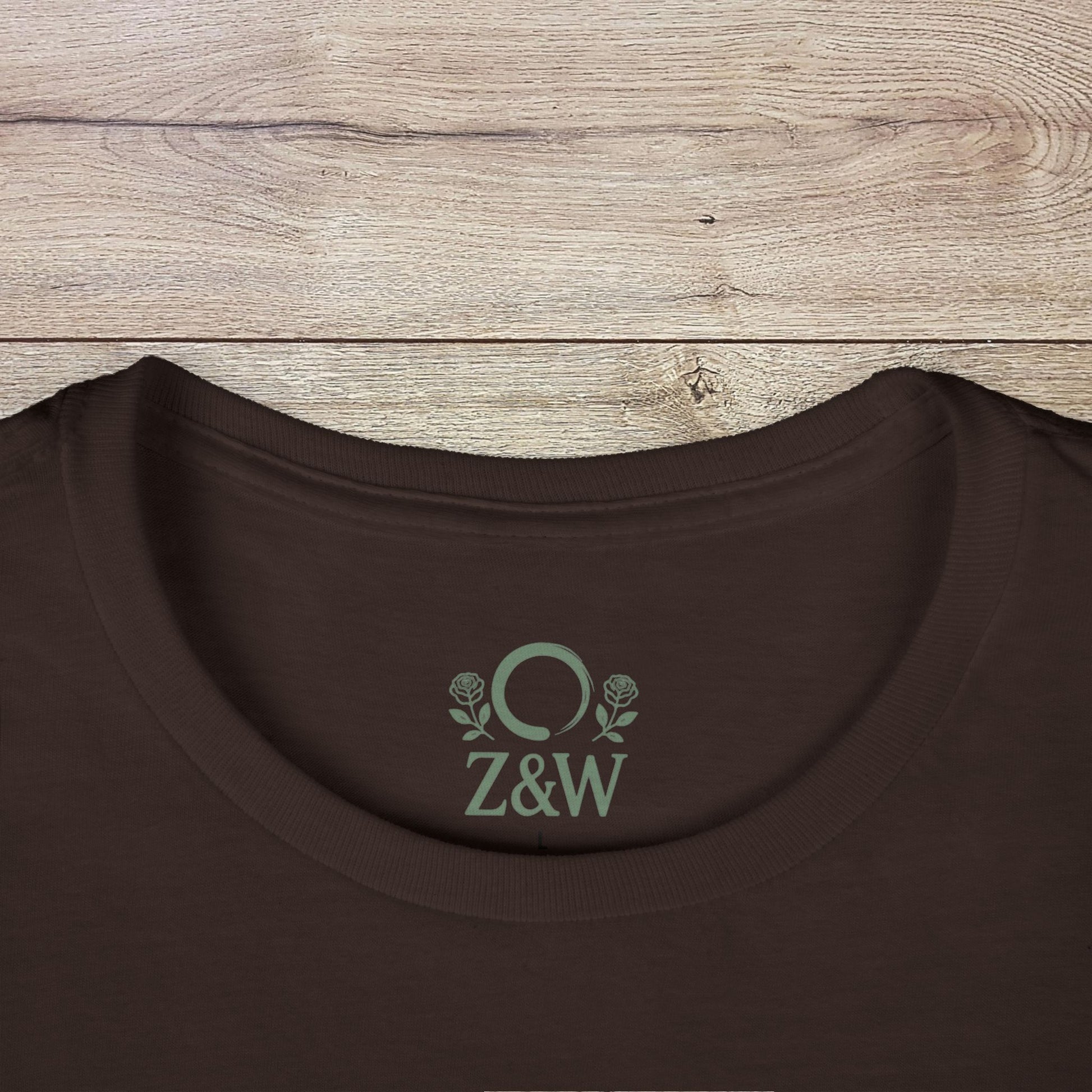 Haunted Happy Hour T-Shirt, Eco-Friendly Cotton, Unisex Ghost Graphic Tee for Halloween Parties - Close-up view of the collar on a brown t-shirt featuring elegant branding.