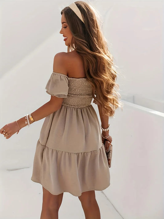Back view of the Full Size Ruffled Off-Shoulder Dress with Short Sleeves - Stretchy, Chic & Ruched Design, highlighting the ruched bodice and flowy skirt in beige on a model.