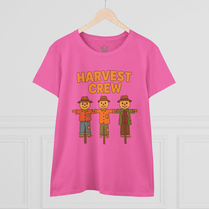 Front view of the Harvest Crew Halloween T-Shirt displayed on a wooden hanger, highlighting its vibrant pink color and playful scarecrow design.