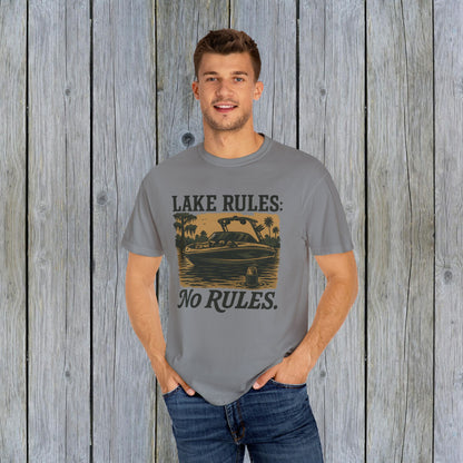 Unisex Garment-Dyed Lake Rules Tee modeled by a young man, showcasing its soft vintage fabric and relaxed fit, perfect for outdoor enthusiasts.