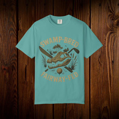Unisex Swamp-Bred Fairway-Fed Tee in vibrant teal, featuring an eye-catching alligator design with golf themes, perfect for summer adventures.