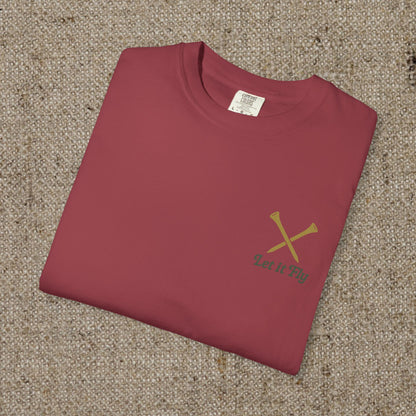 Tee It High Let It Fly Graphic Tee in maroon, neatly folded and displayed on a textured surface, highlighting its soft cotton fabric and durable design.