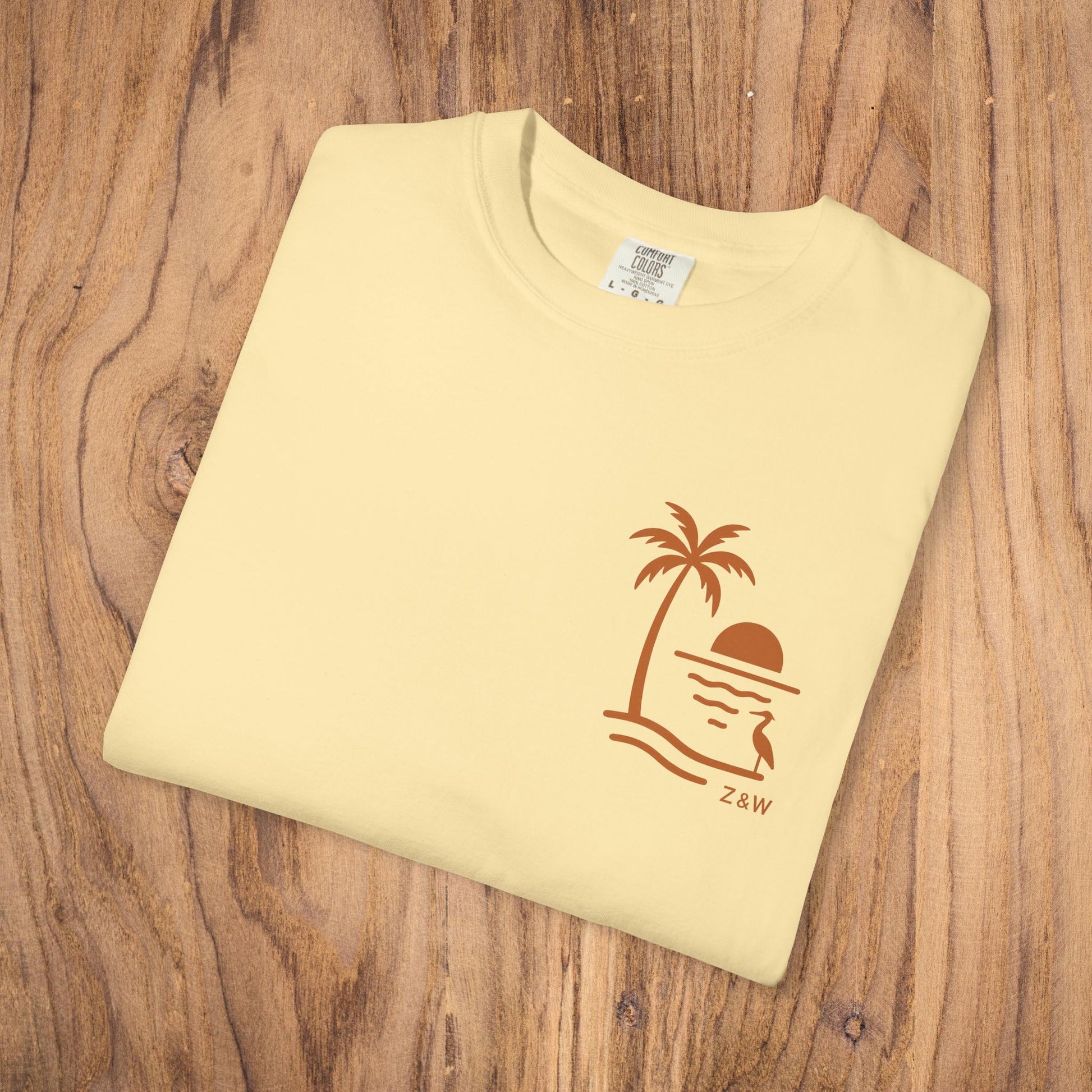 Unisex Sunset Palm Tree T-Shirt showcased in soft yellow, featuring a vibrant palm tree design, ideal for summer festivals and outdoor events.