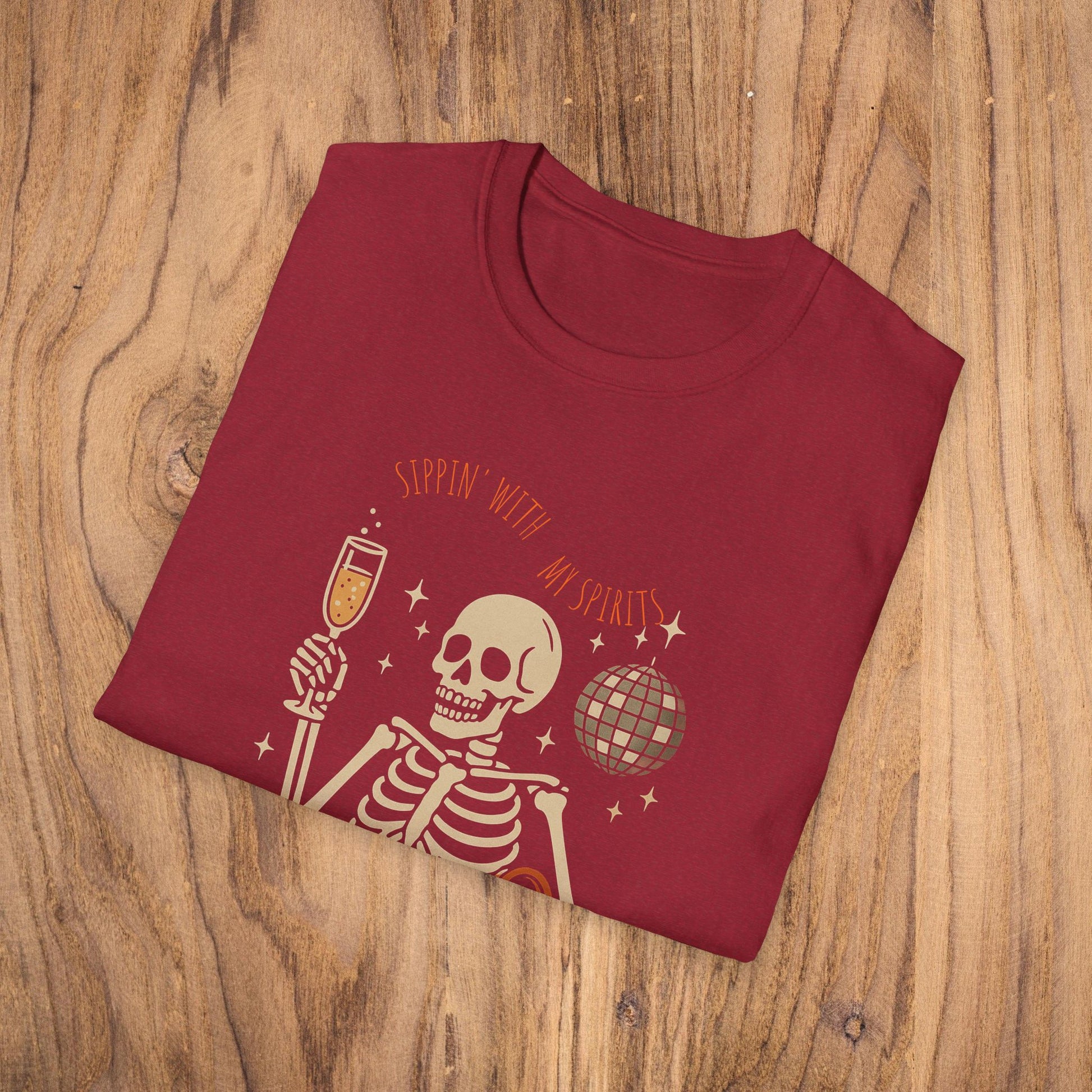 Spooky Spirits Graphic Tee in dark red displaying a playful skeleton with a beverage, great for Halloween festivities.
