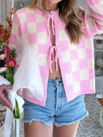 Checkered Tie-Front Cropped Cardigan for Women - Slightly Stretchy, 100% Polyester Fabric, combined with a floral bouquet, highlighting the playful pink checkered look.