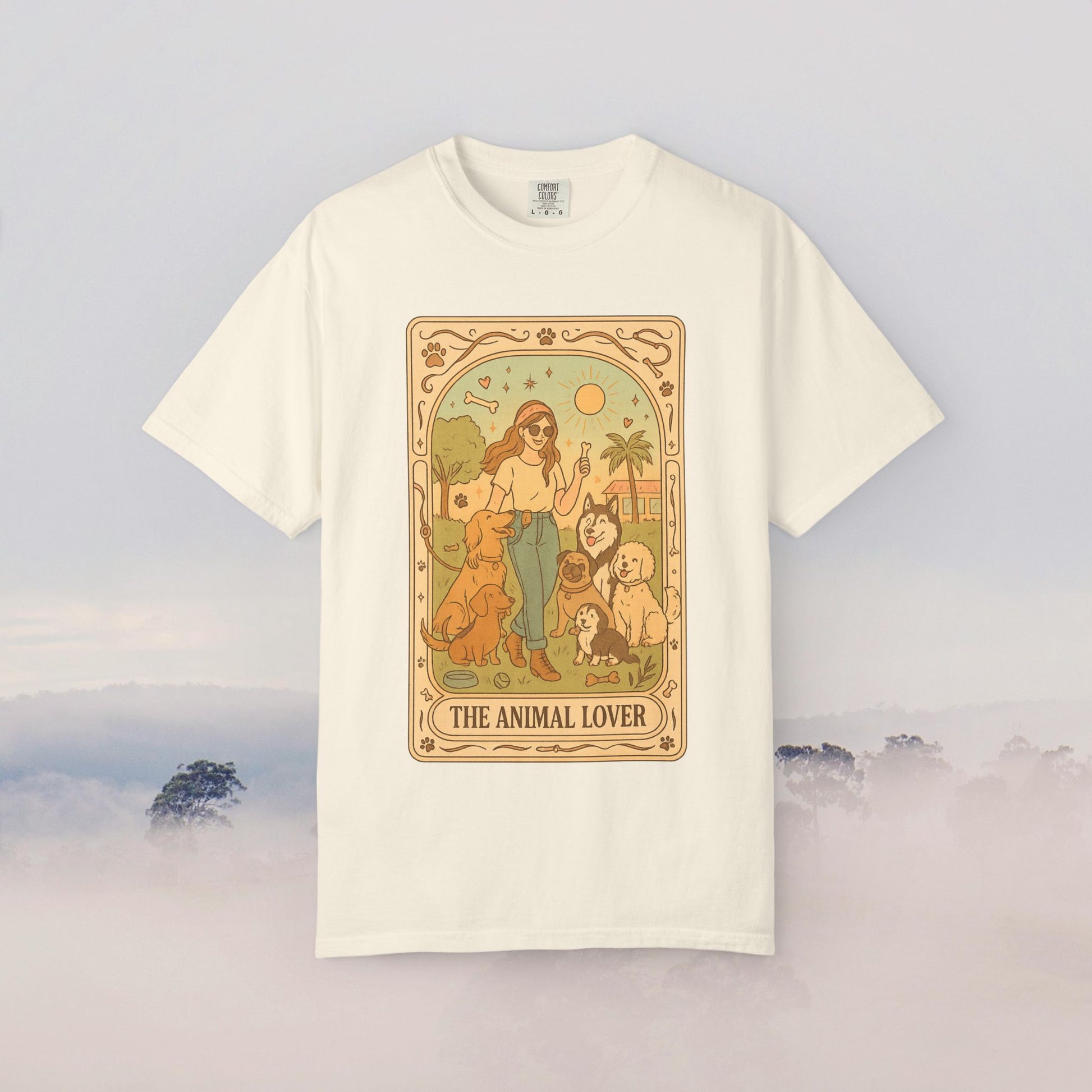 Animal Lover Tarot Tee in cream color, featuring an illustration of a woman surrounded by various pets, made from 100% soft cotton, available in sizes S to 4XL, eco-friendly and durable.