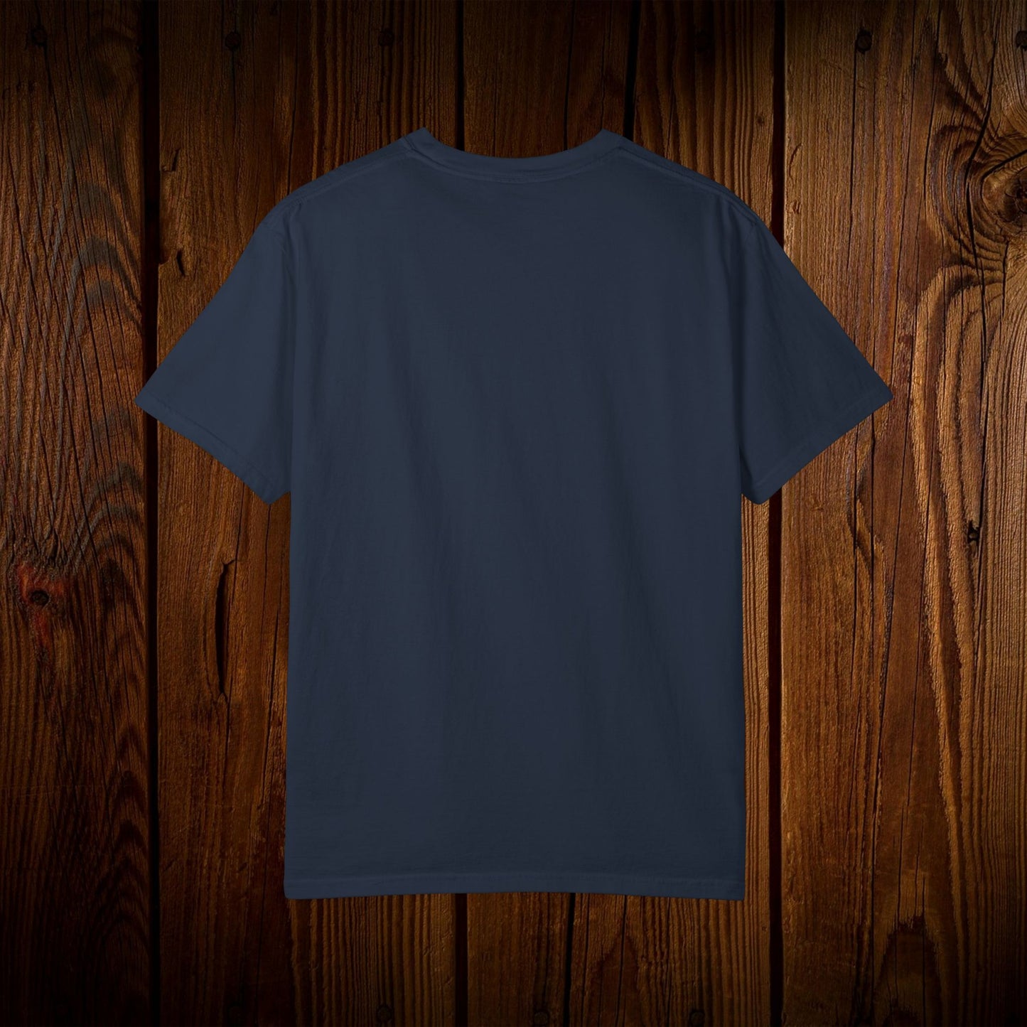 Back view of the Unisex Swamp-Bred Fairway-Fed Tee on wooden background, emphasizing its durability and comfort.