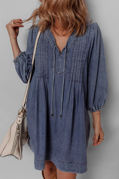 Front view of a model in the Tie Neck Long Sleeve Mini Denim Dress, emphasizing the stylish neckline and comfortable silhouette.